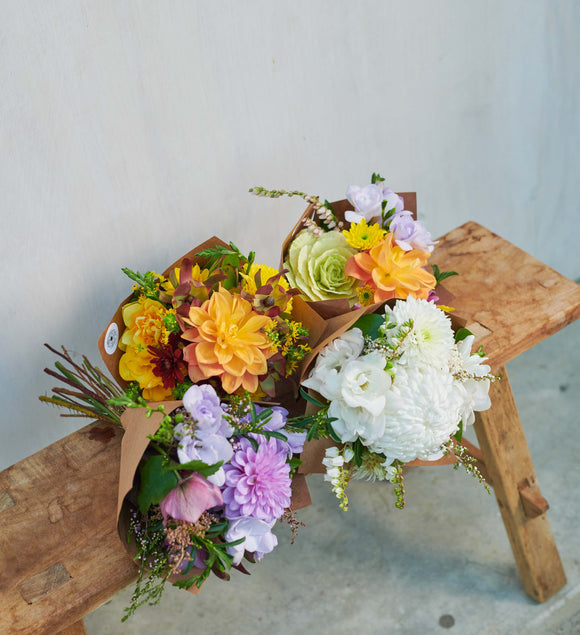 Colourful-flower-bouquets-on-wooden-stool