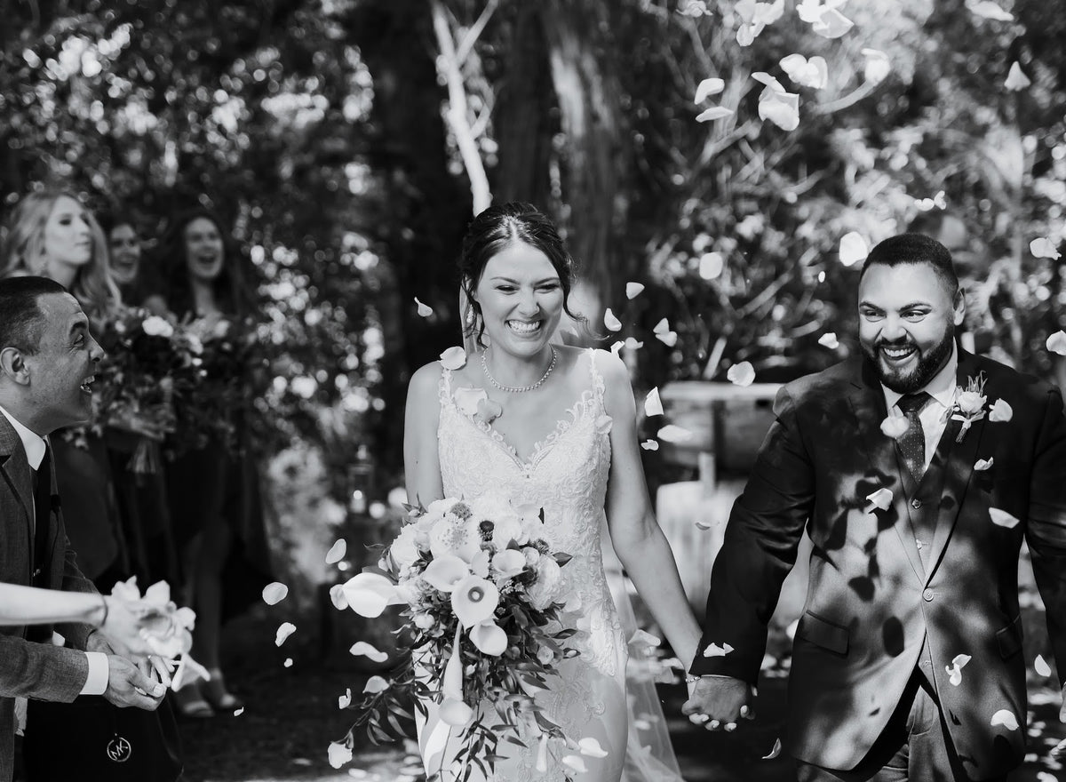 BLACK-WHITE-IMAGE-OF-BRIDE-AND-GROOM-WALKING-DOWN-AISLE