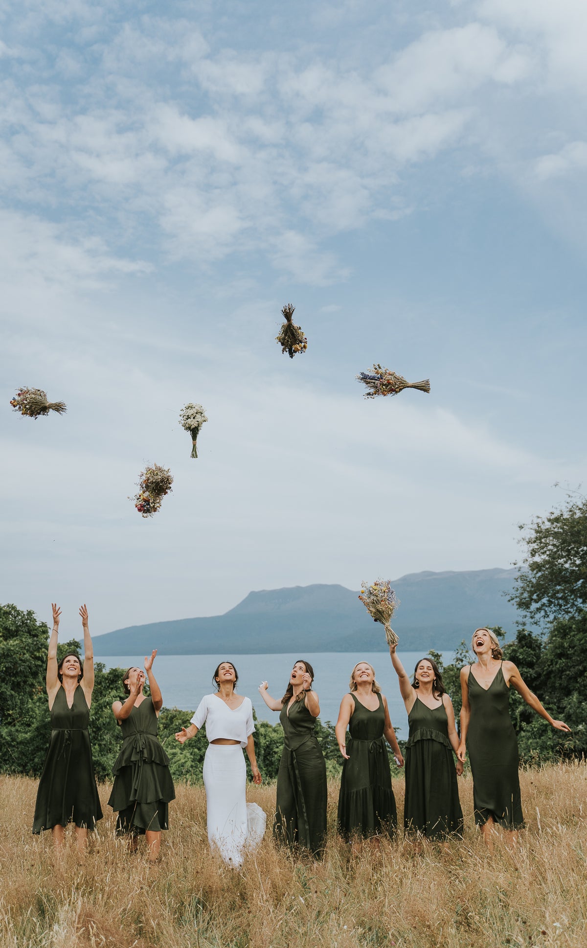 BRIDAL-PARTY-THROWING-BOUQUETS-IN-AIR