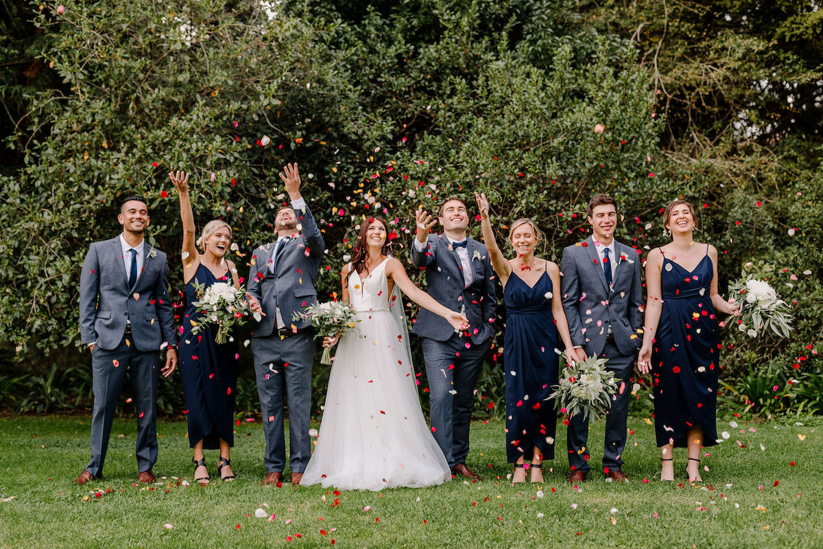 BRIDAL-PARTY-THROWING-PETALS-IN-AIR
