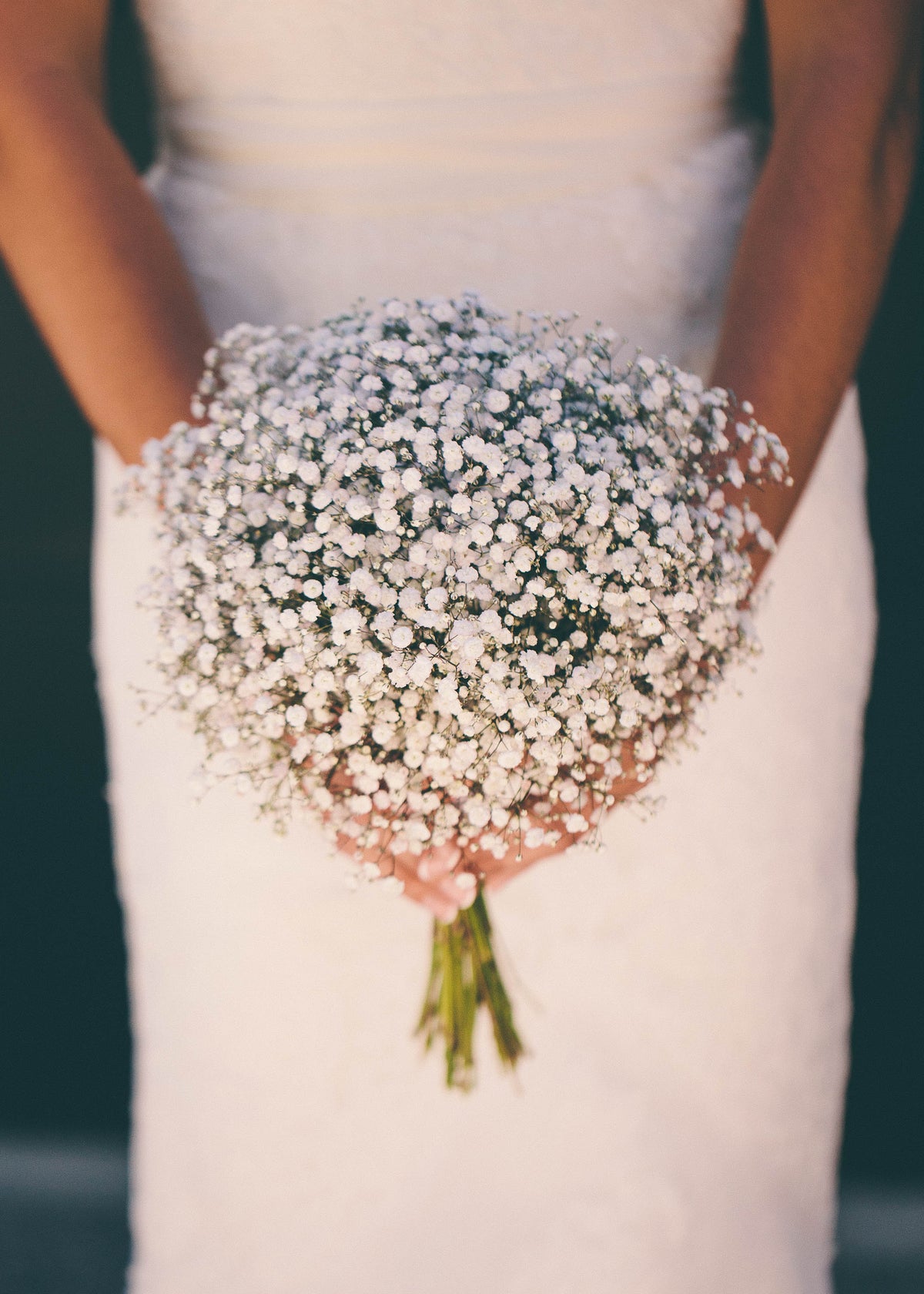 BRIDE-HOLDING-WHITE-FLOWER-BOUQUET