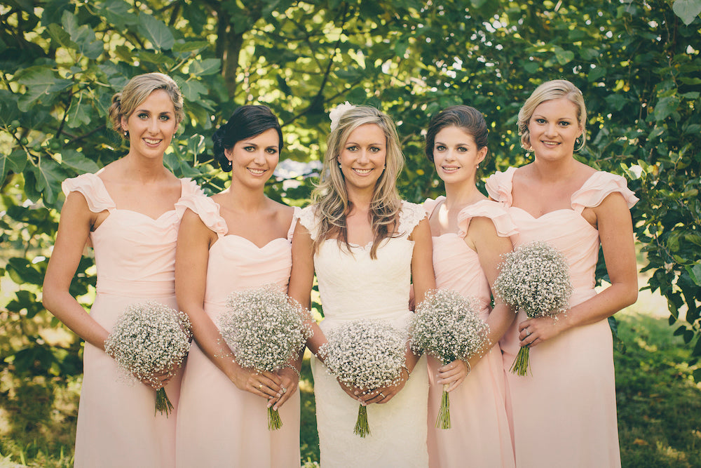 BRIDES-AND-BRIDESMAIDS--HOLDING-WHITE-FLOWER-BOUQUETS