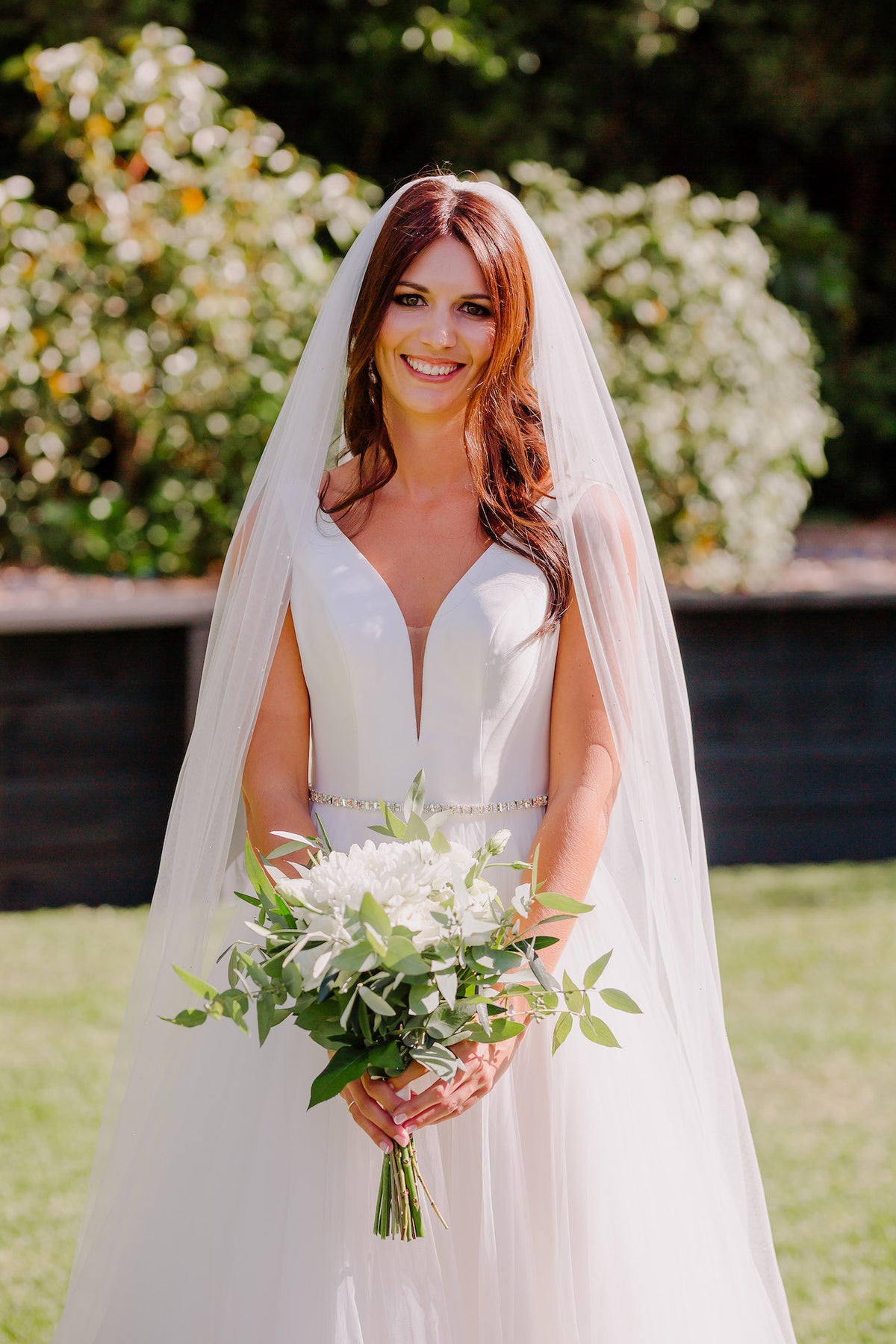 BRIDE-HOLDING-WHITE-BOUQUET-OUTSIDE