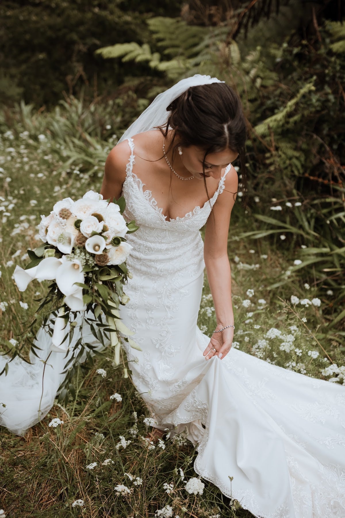 BRIDE-IN-FOREST-HOLDING-WHITE-BOUQUET