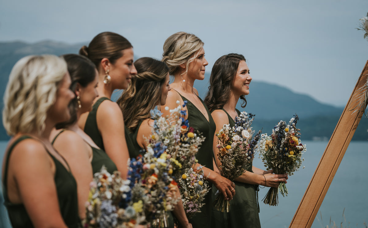 SIDE-VIEW-OF-BRIDESMAIDS-STANDING-HOLDING-BOUQUETS