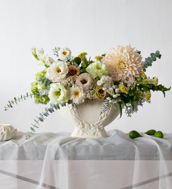 CREAM-LARGE-FLOWER-ARRANGEMENT-ON-TABLE