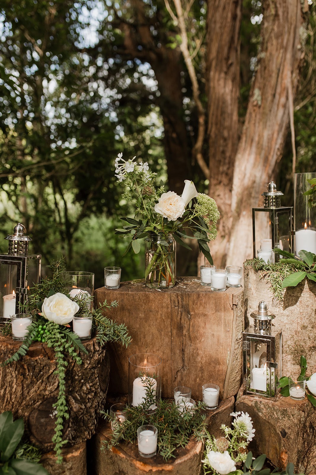 FOREST-AISLE-SET-UP-CANDLES-ON-TREE-STUMPS