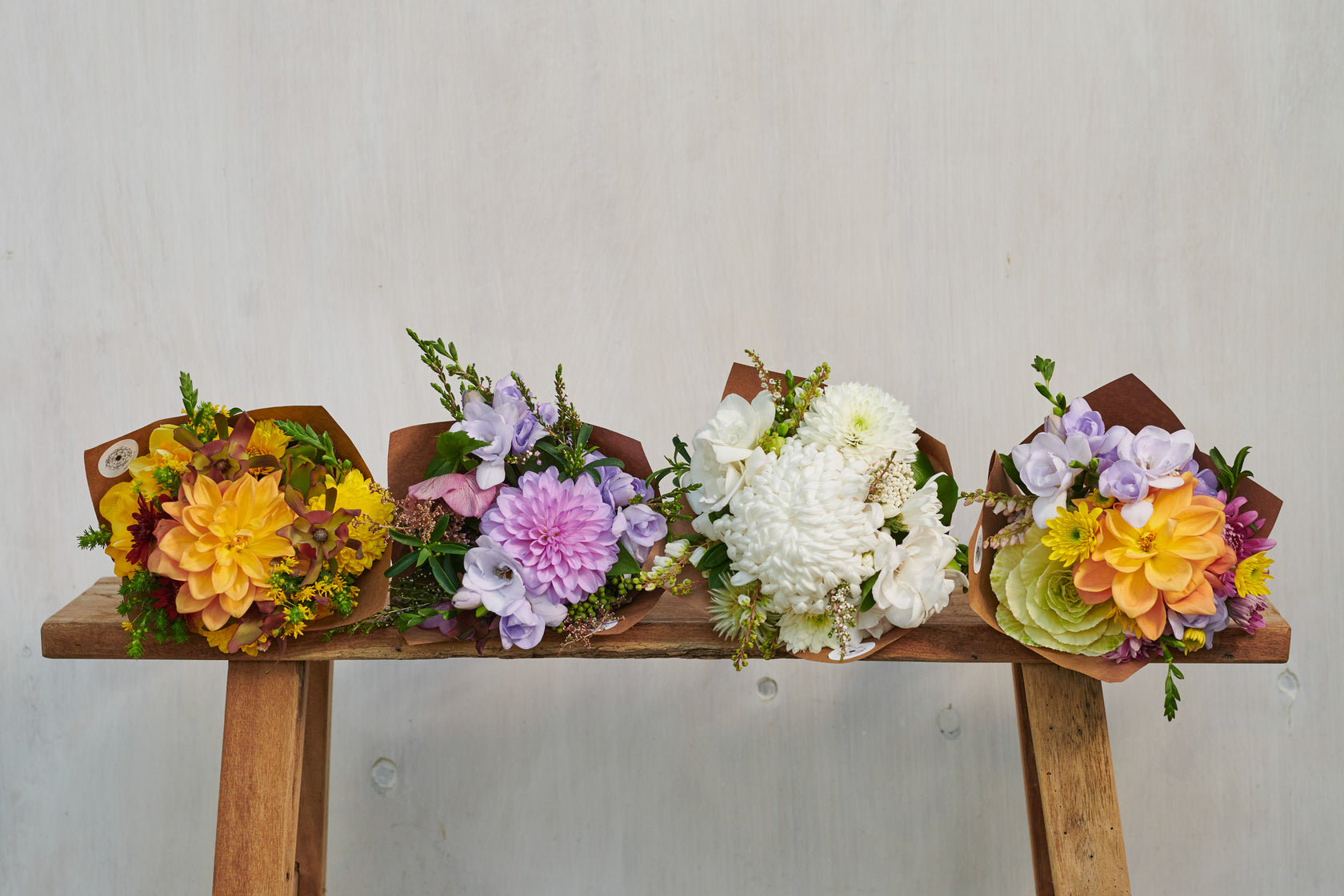 FOUR-FLOWER-BOUQUETS-ON-WOODEN-STOOL
