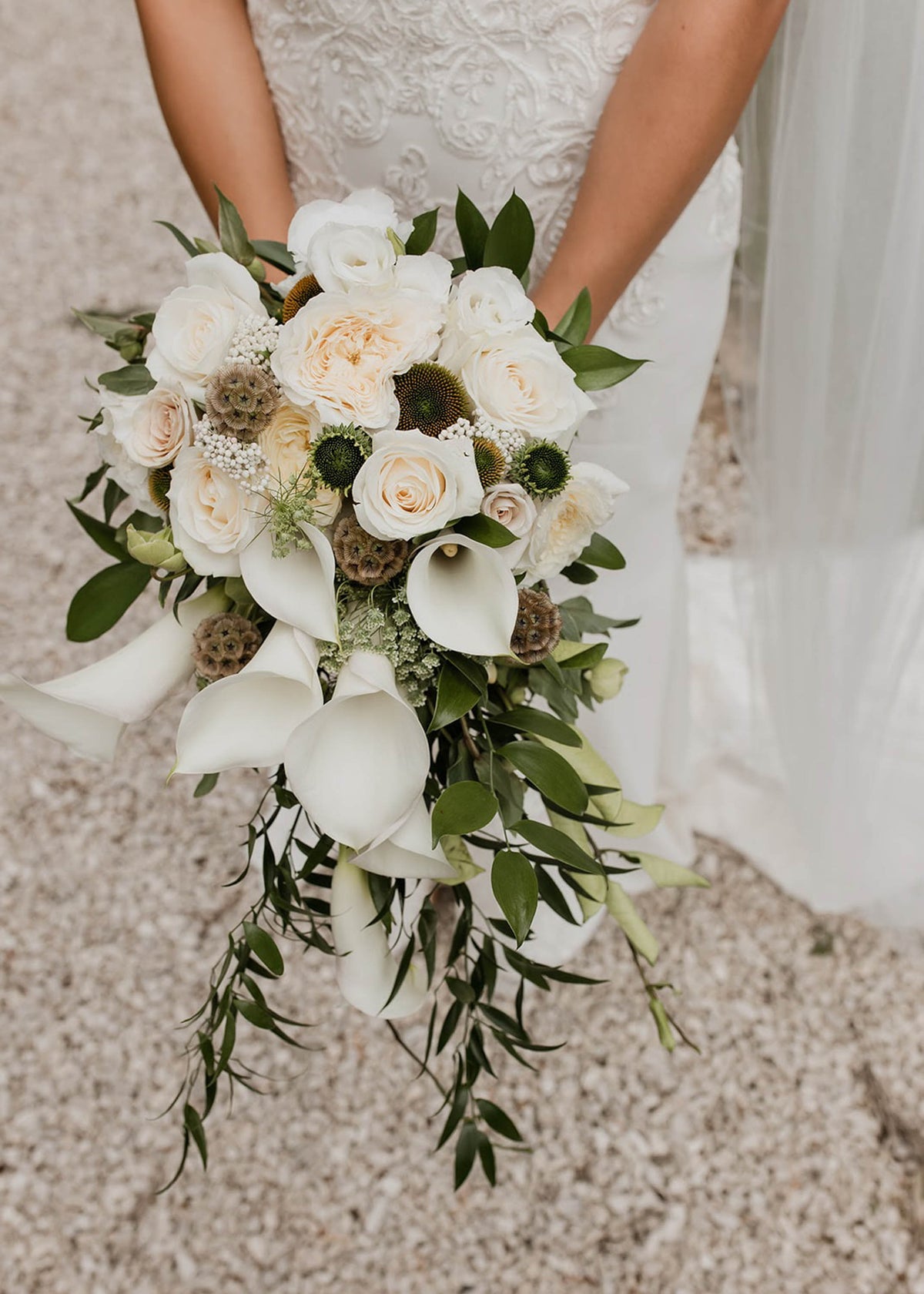 WHITE-BRIDAL-FLOWER-BOUQUET-BEING-HELD-BY-BRIDE