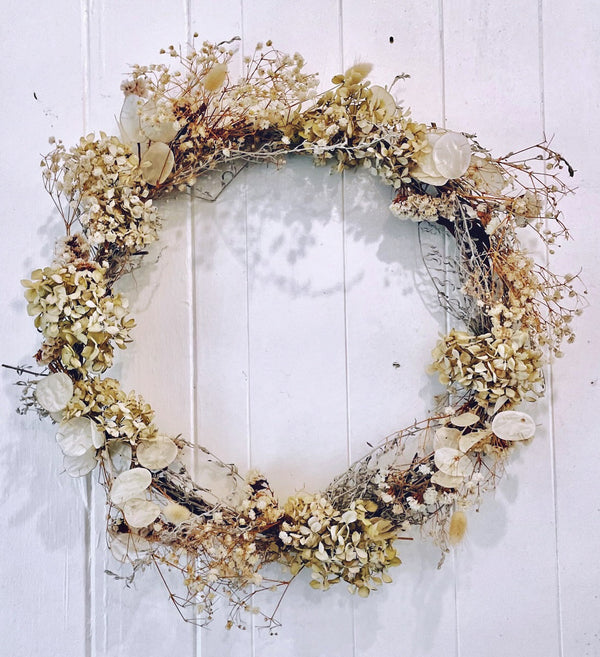 Botanics-cream-round-wreath-hanging-on-wall