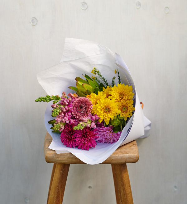 Botanics-staged-bright-flower-bouquet-on-stool