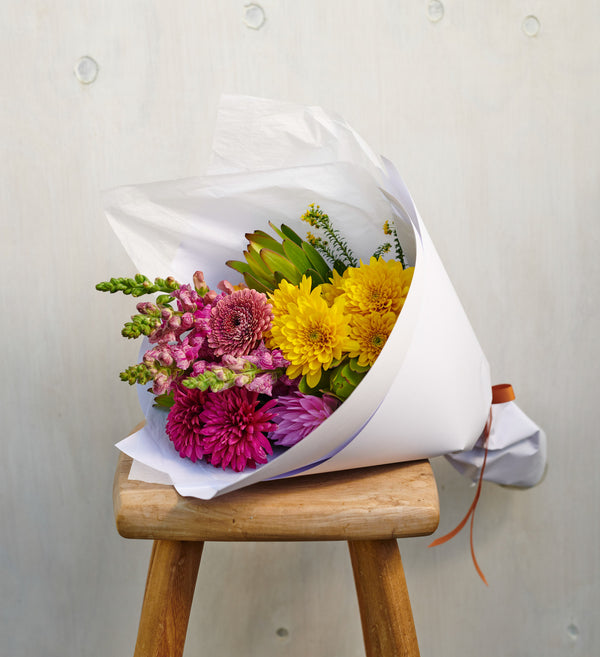 Botanics-bright-staged-flower-bouquet-on-wooden-stool