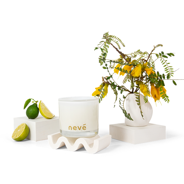 Neve candle with kowhai blossom branch and limes