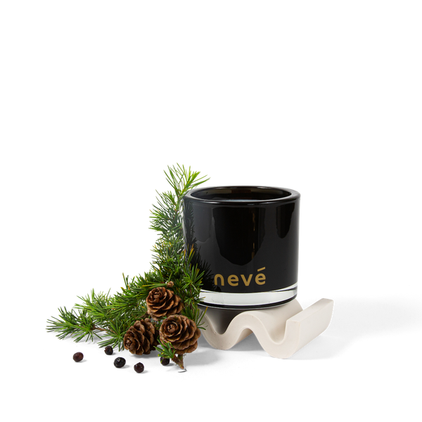 Black candle with wild pines and juniper berry branch