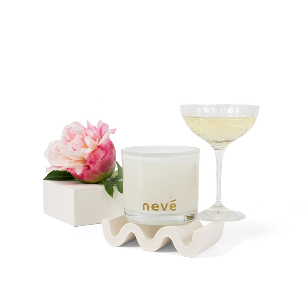 White candle and peony with prosecco glass 