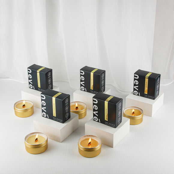 Multiple Mini gold travel tin candles on display with boxes